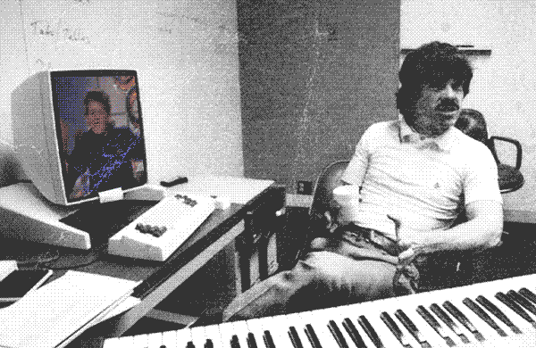 alan kay sitting at computer with animated kid dancing on screen