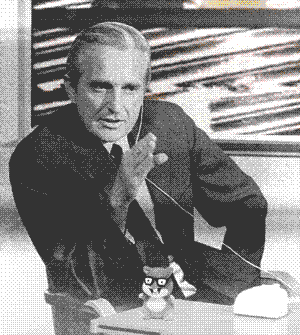 1960's photo of doug englebart at a computer with animated max headroom on screen behind him